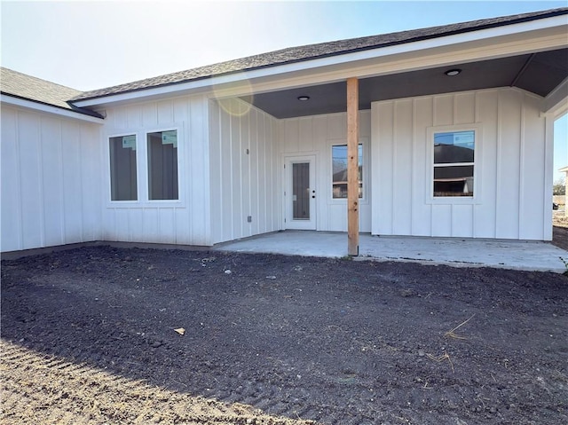 property entrance with a patio and board and batten siding