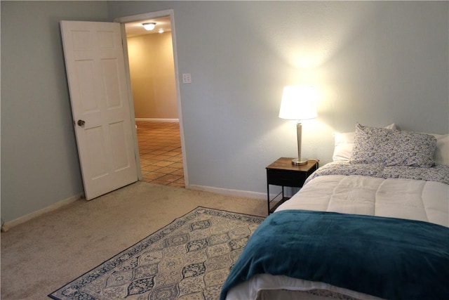 bedroom featuring baseboards and light colored carpet