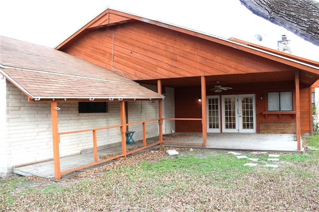 rear view of house featuring a shingled roof, a ceiling fan, french doors, a patio area, and brick siding