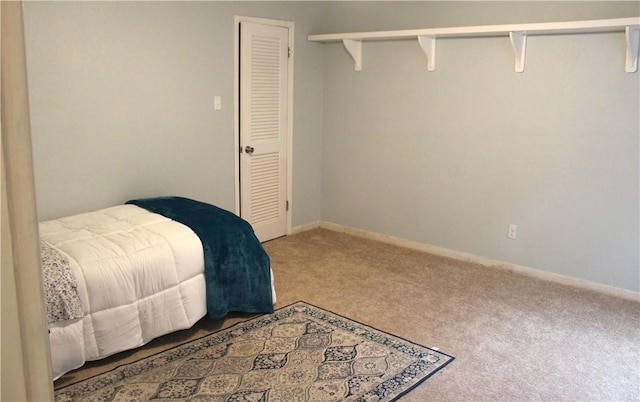 carpeted bedroom featuring baseboards