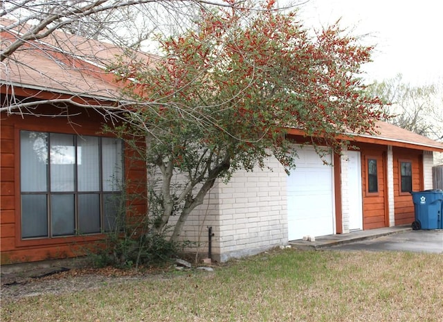 view of property exterior with a yard and brick siding