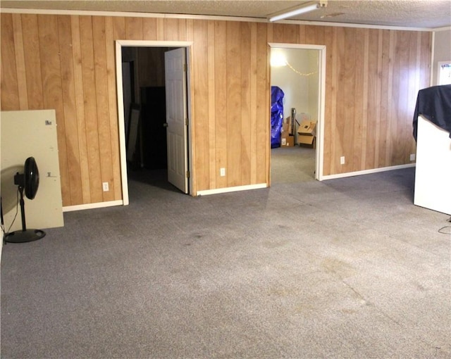 empty room with wood walls and dark colored carpet