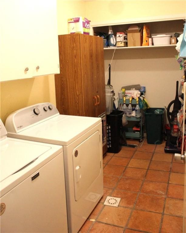 laundry area featuring cabinet space, tile patterned flooring, and independent washer and dryer