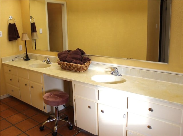 bathroom with tile patterned floors, a sink, and double vanity