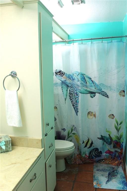 full bath with vanity, toilet, and tile patterned floors