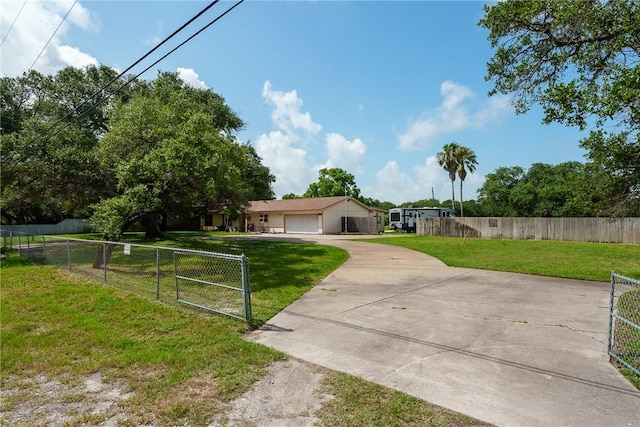1689 Mooney Ln, Ingleside, TX 78362 - view of front of property featuring concrete driveway, a garage, and a gate