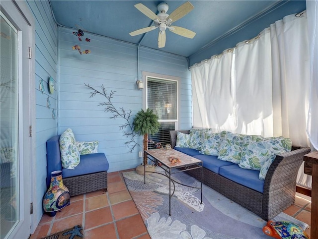 sunroom featuring a ceiling fan