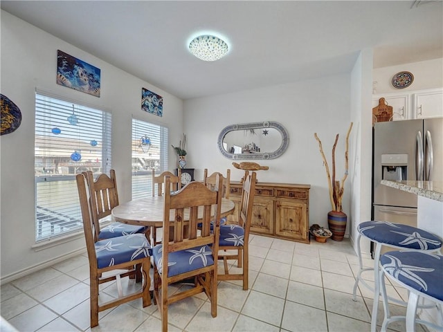 dining space featuring light tile patterned flooring