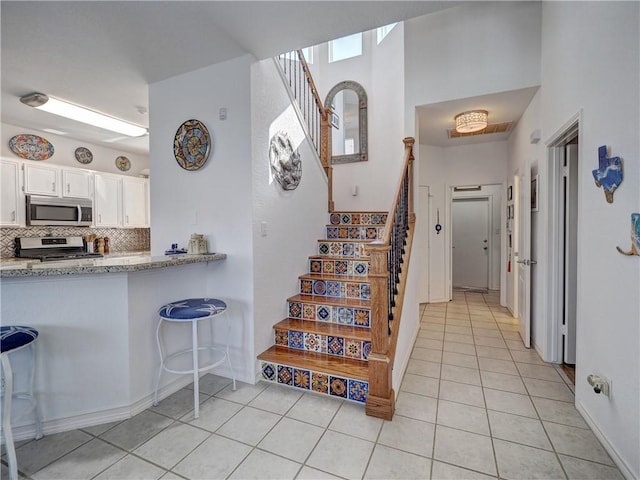 interior space with tile patterned flooring and baseboards