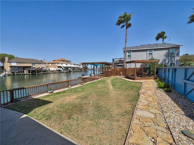 view of yard featuring a water view, a fenced backyard, and a pergola