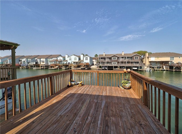 dock area with a residential view and a deck with water view