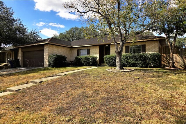 single story home with a front yard and a garage