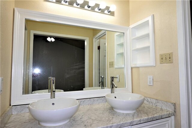 bathroom with built in shelves and vanity