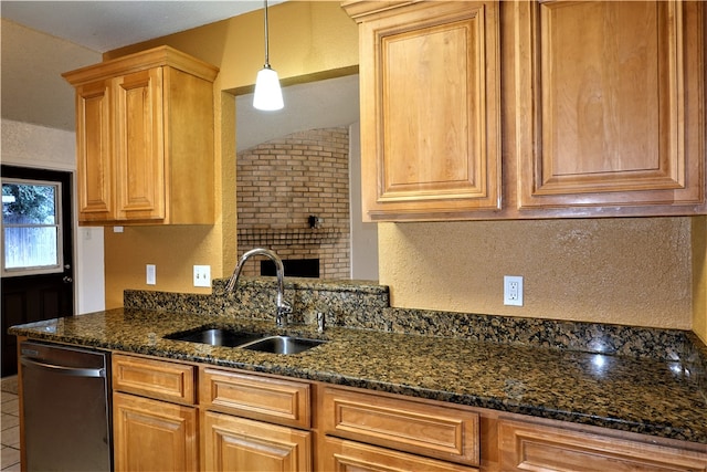 kitchen with dishwasher, decorative light fixtures, sink, and dark stone counters