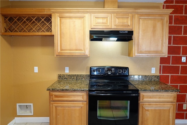 kitchen with black range with electric stovetop, dark stone countertops, tile patterned flooring, and light brown cabinets