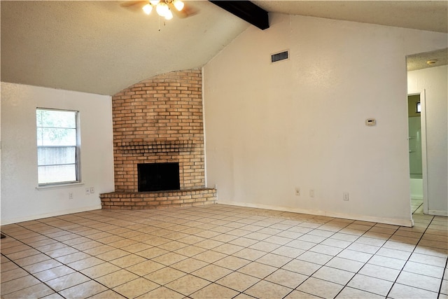 unfurnished living room featuring vaulted ceiling with beams, ceiling fan, a fireplace, and light tile patterned floors