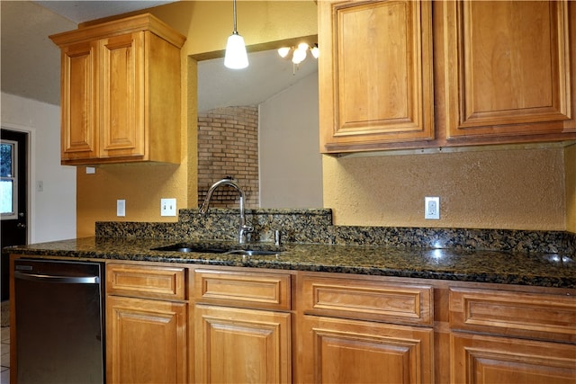 kitchen with dishwasher, decorative light fixtures, dark stone counters, and sink