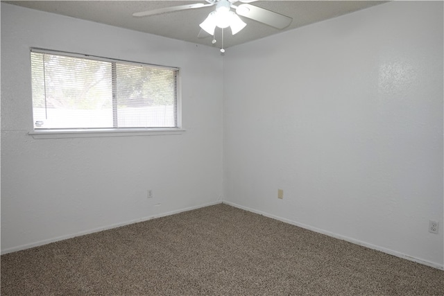 spare room featuring ceiling fan and carpet floors