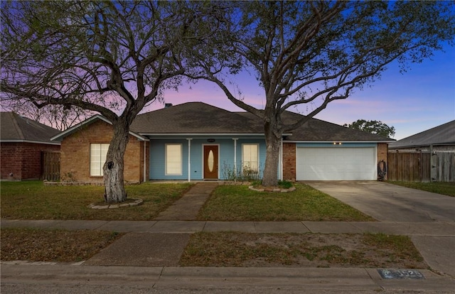 ranch-style home featuring a yard and a garage