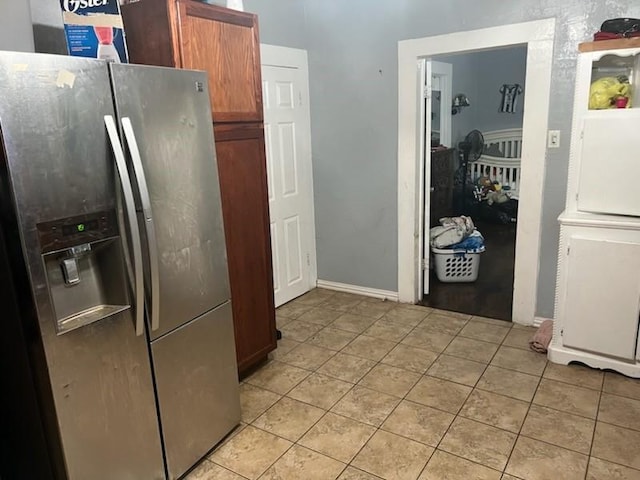 604 N Ironwood Ave, Bishop, TX 78343 - kitchen with light tile patterned flooring, stainless steel fridge with ice dispenser, and brown cabinetry