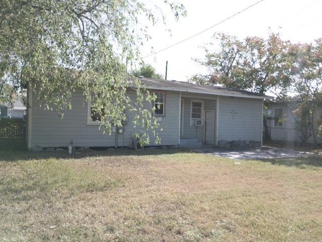 back of house with a lawn