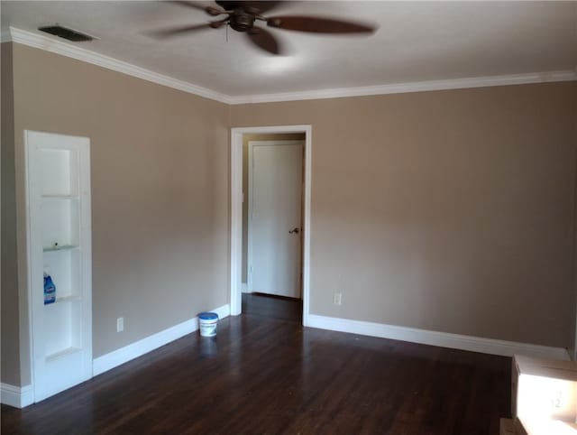 empty room featuring dark hardwood / wood-style flooring, ceiling fan, and crown molding