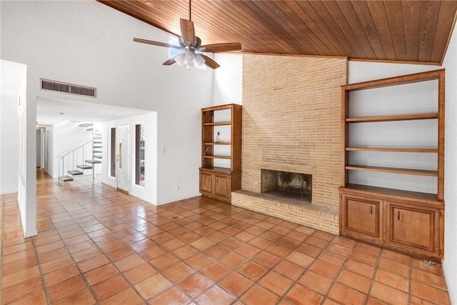 6002 Parkland Dr, Corpus Christi, TX 78413 - unfurnished living room featuring wood ceiling, ceiling fan, tile patterned flooring, a brick fireplace, and built in shelves