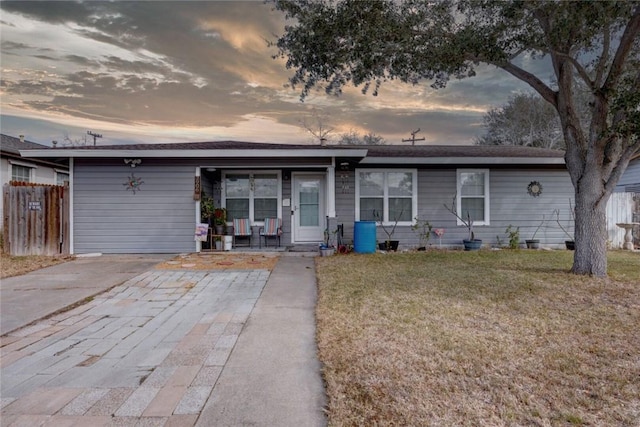 ranch-style house featuring a lawn