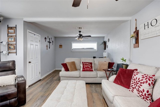 living room with beamed ceiling, ceiling fan, and wood-type flooring