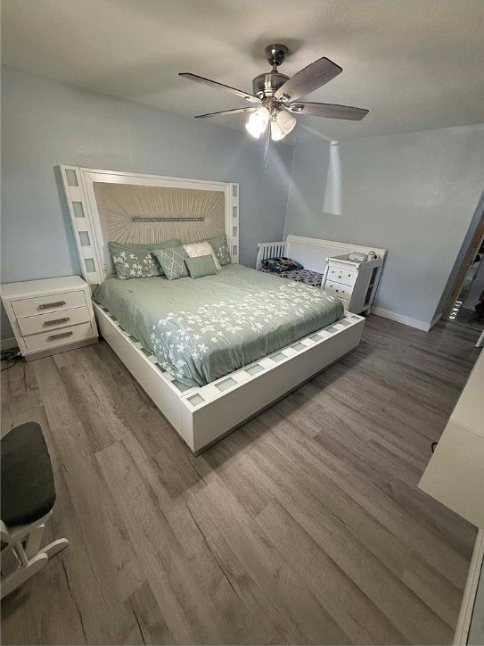 bedroom featuring ceiling fan and wood-type flooring