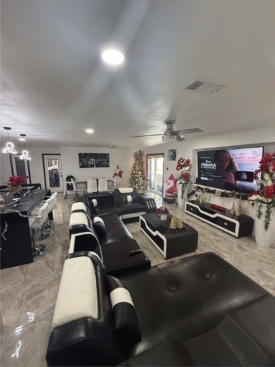 home theater room featuring ceiling fan