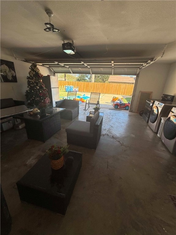 garage featuring a garage door opener, white refrigerator, separate washer and dryer, and a pool