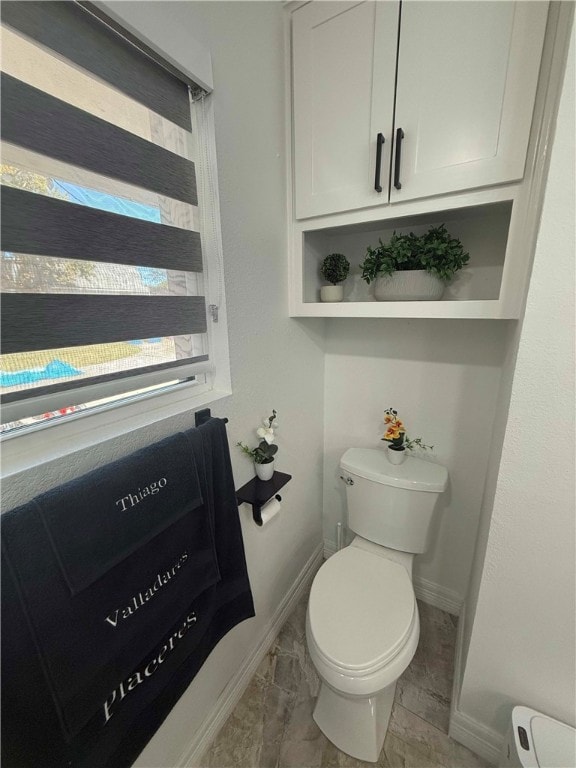 bathroom featuring toilet and baseboard heating