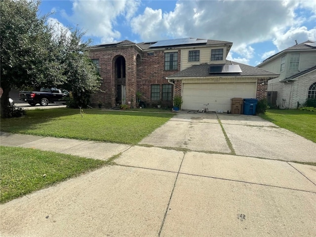 view of front of house with a front yard, solar panels, and a garage