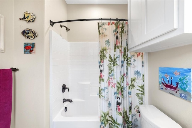 bathroom with toilet and shower / bath combo with shower curtain