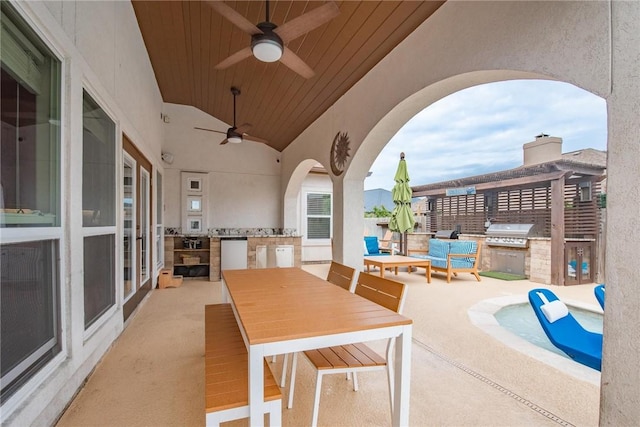 view of patio featuring outdoor dining space, a ceiling fan, exterior kitchen, and area for grilling