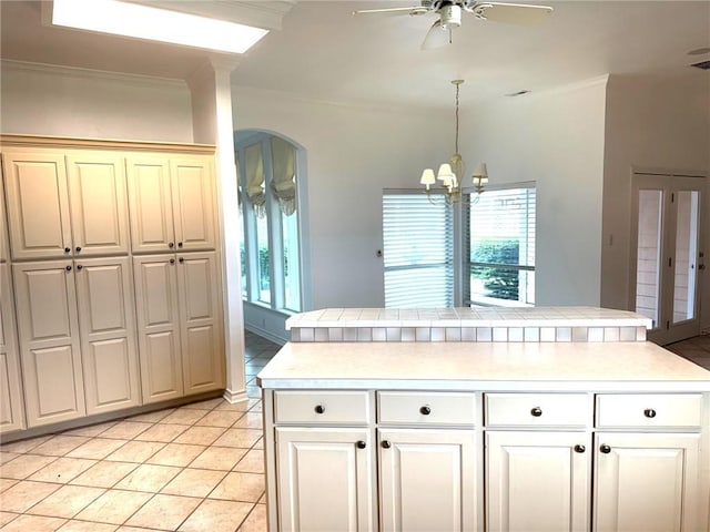 718 Broadway Blvd, Portland, TX 78374 - kitchen with ornamental molding, ceiling fan, arched walkways, light tile patterned floors, and hanging light fixtures
