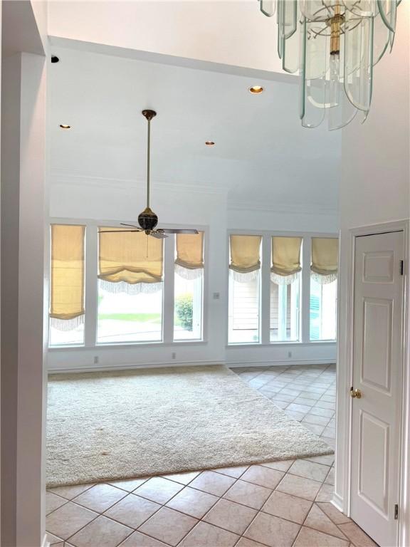 718 Broadway Blvd, Portland, TX 78374 - entryway with light tile patterned flooring, plenty of natural light, light carpet, ornamental molding, and a chandelier