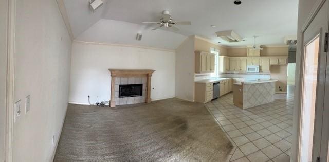 718 Broadway Blvd, Portland, TX 78374 - kitchen with open floor plan, white microwave, a ceiling fan, a tile fireplace, and ornamental molding