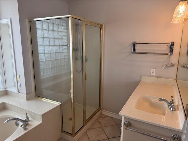 718 Broadway Blvd, Portland, TX 78374 - full bath with a shower stall, tile patterned flooring, a bath, vanity, and baseboards