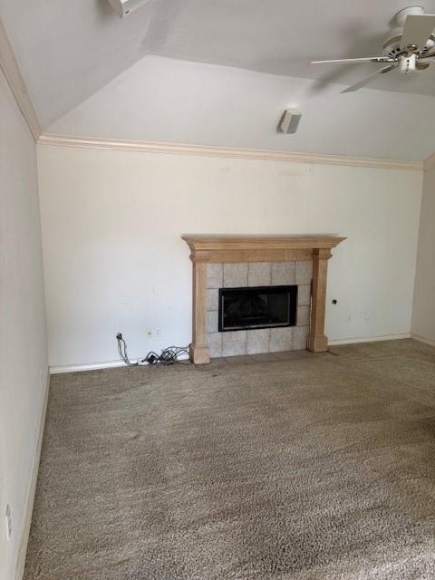 718 Broadway Blvd, Portland, TX 78374 - unfurnished living room with vaulted ceiling, ceiling fan, carpet, a tiled fireplace, and crown molding