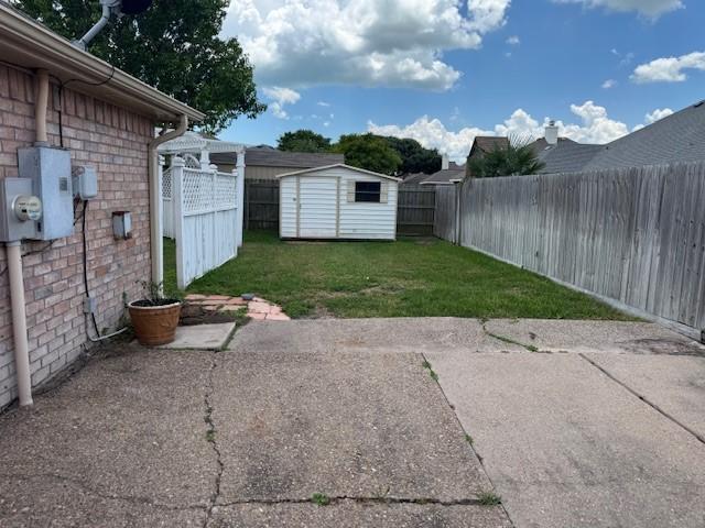 718 Broadway Blvd, Portland, TX 78374 - view of yard featuring a patio, a storage shed, and an outbuilding