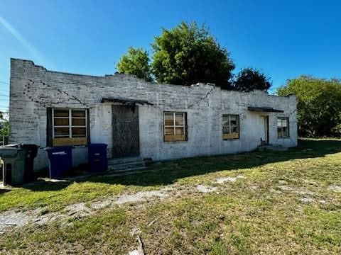 back of property featuring a lawn