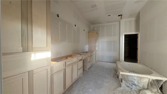 bathroom with a tub and concrete floors