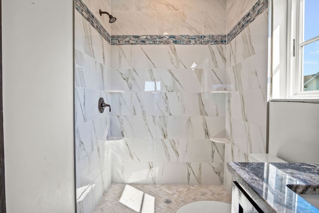 bathroom with tiled shower