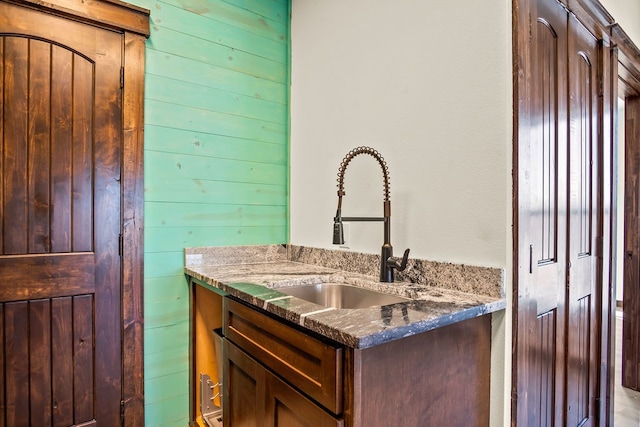 bathroom featuring wood walls and vanity