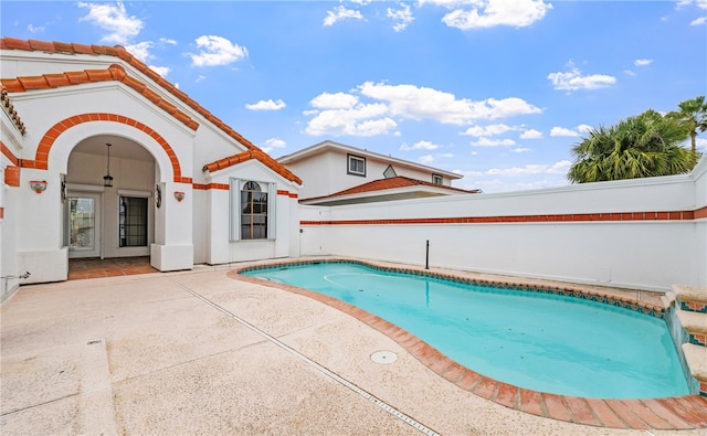 view of swimming pool with a fenced in pool and a patio