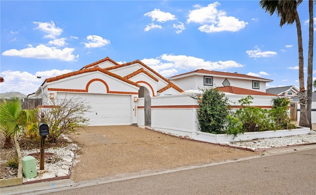 view of front of property with driveway, an attached garage, a tile roof, and stucco siding