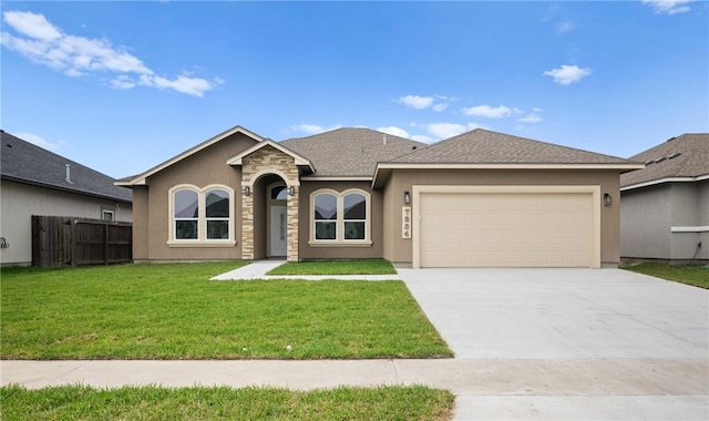 single story home with a garage and a front lawn