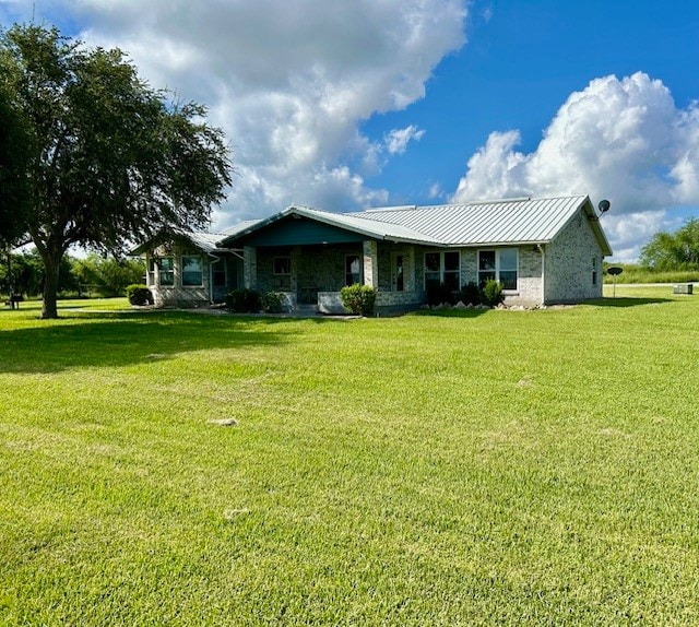 back of property featuring a lawn